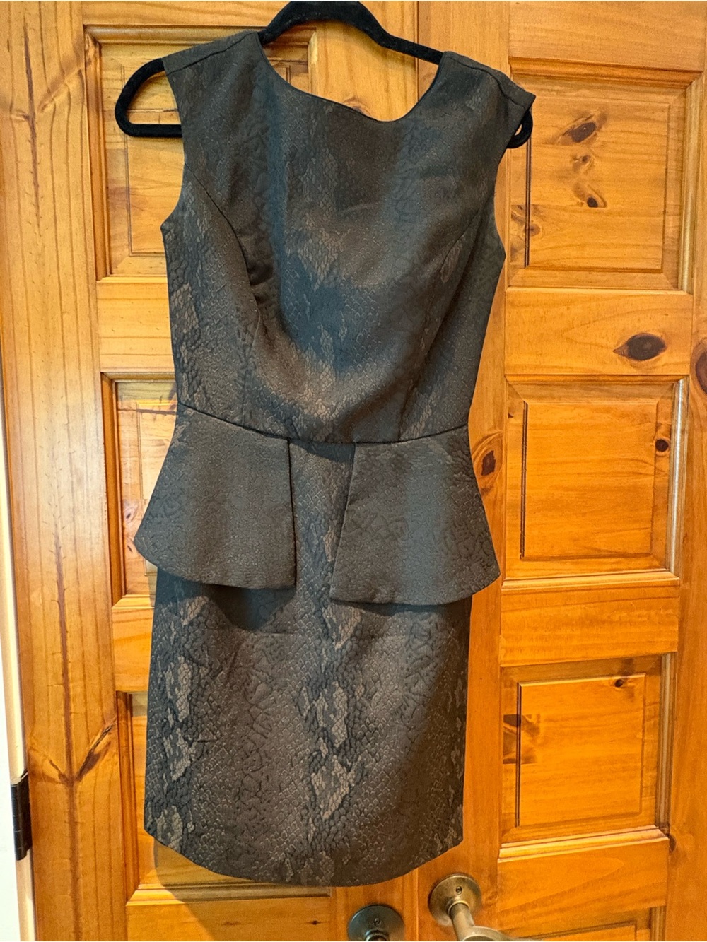 Sleeveless Peplum Sheath Dress in black with snakeskin detail